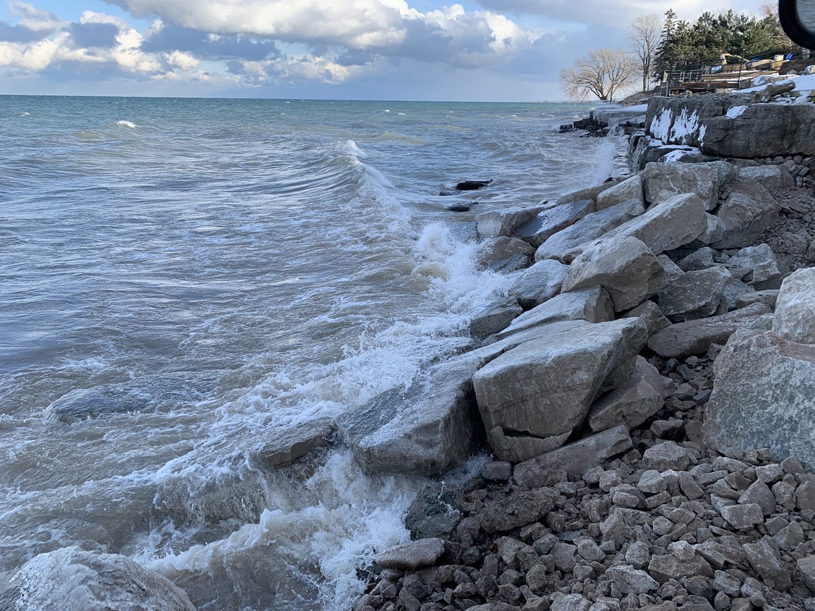 Waves breaking against the armour stone revetment on the Lake Ontario shoreline at Grimsby